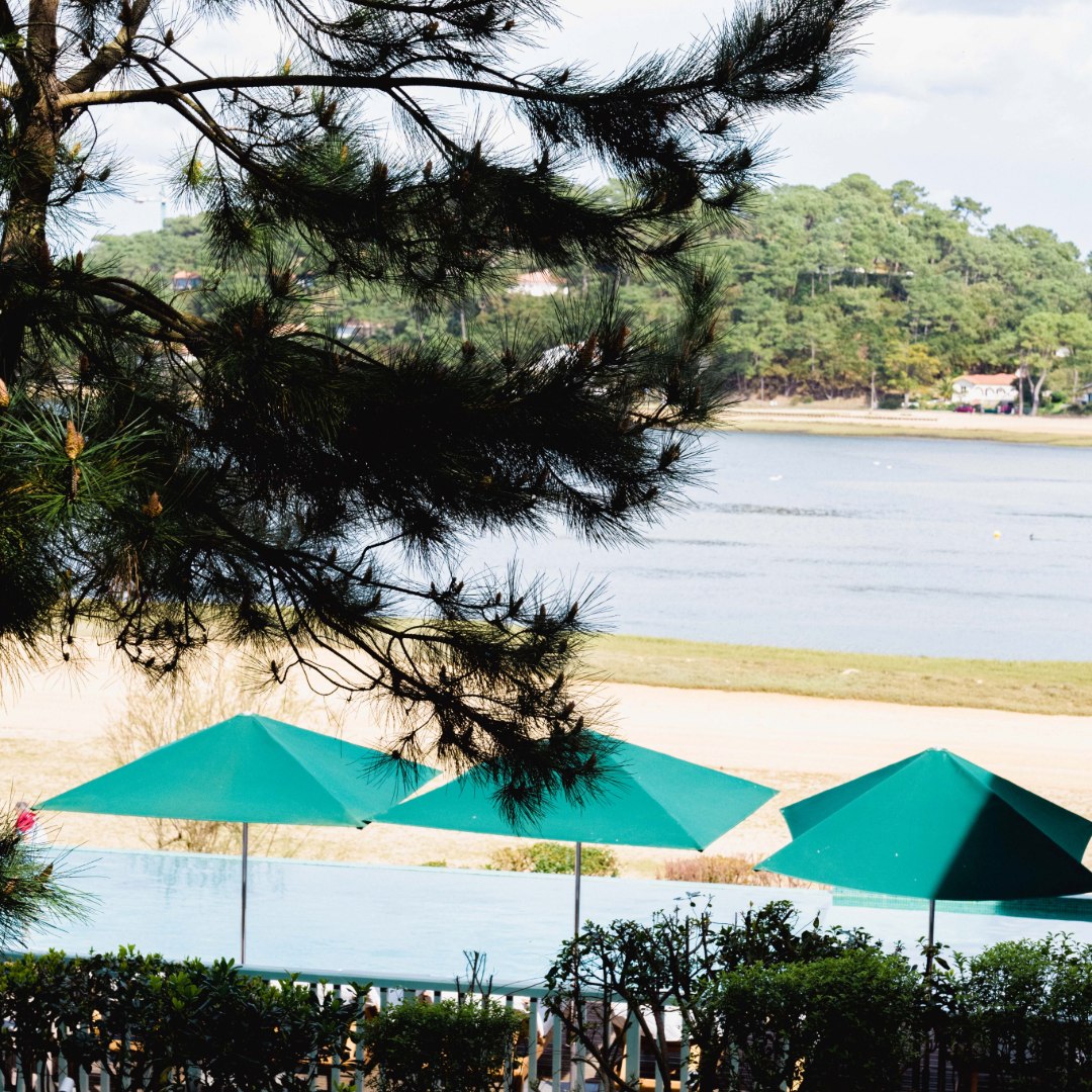 View of the swimming pool and Hossegor lake from Les Hortensias du Lac and the lake view superior room